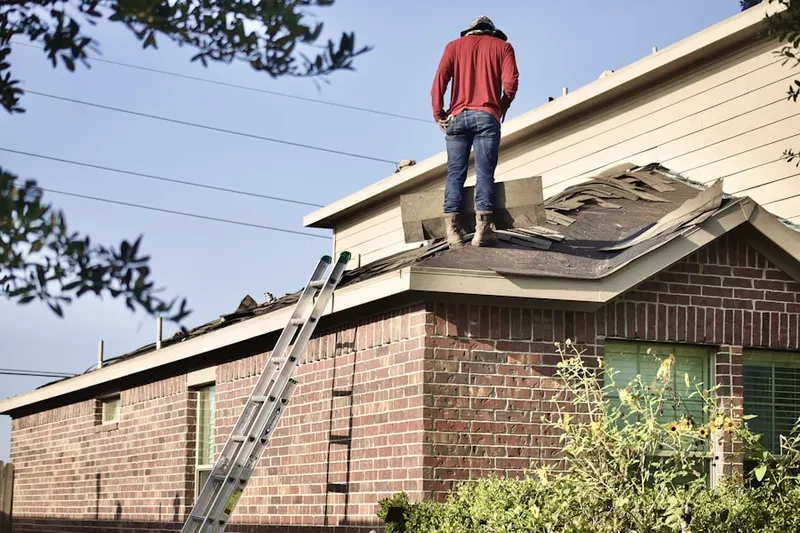 Professional roofer working on a residential roof in Allen Jay